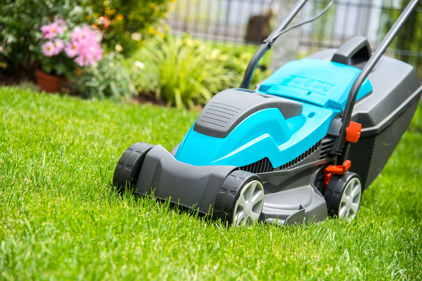 lawn mower on a green meadow